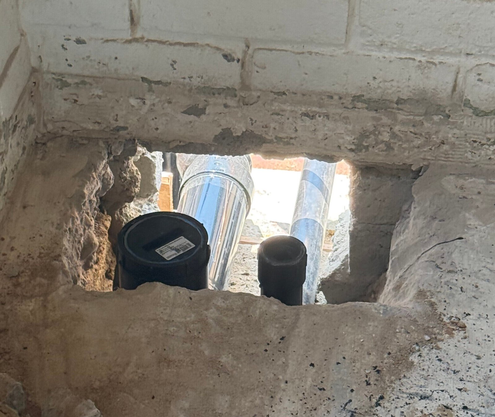 Technician installing a water filtration system in an Oceanside, CA home